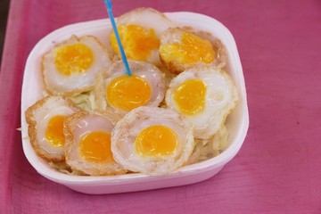 Grilled quail eggs in a pan pits