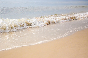 Sand and wave at the beach for background.
