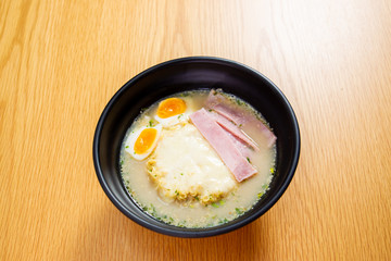 Ham cheese and boiled egg noodle on the wooden table close up.