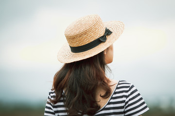 Portrait of Pretty Asian girl wearing a hat on blurred background.  Processed in vintage color tone.