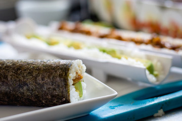 Home made sushi with components in the background