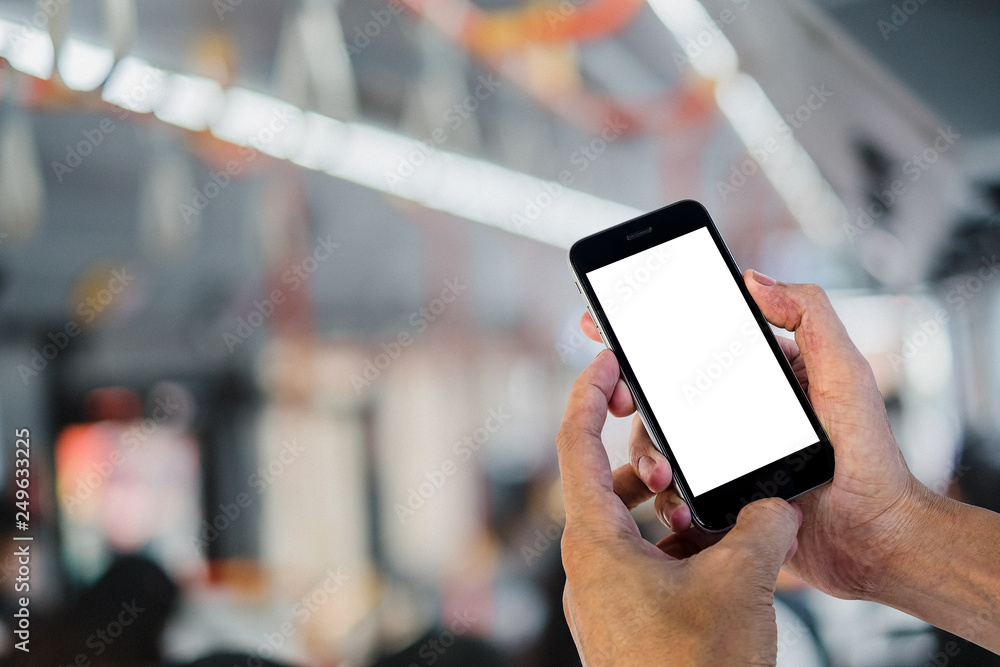 Poster man hands using smart phone with blurred electric train background. blank screen for graphics displa