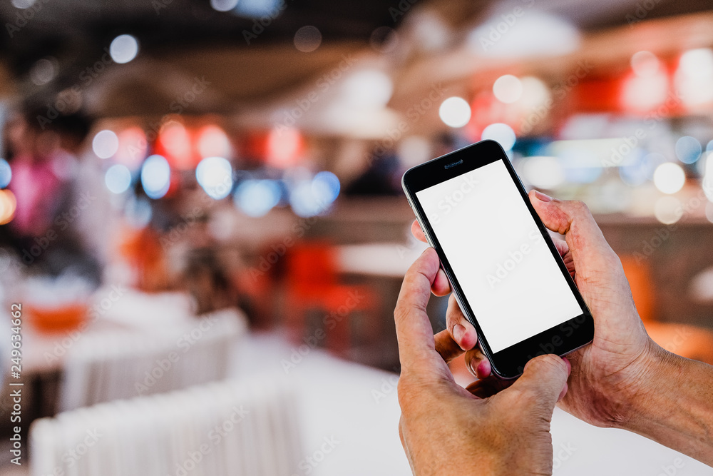 Poster man hands using smart phone with blurred coffee cafe background. blank screen for graphics display m