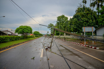 Storm of electric poles falling on the road