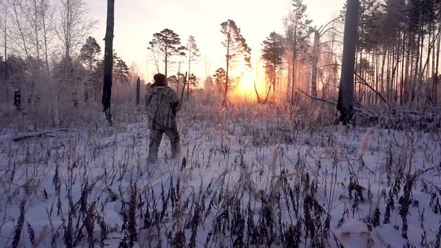 Hunters in the Woods. Armed Rangers in winter forest
