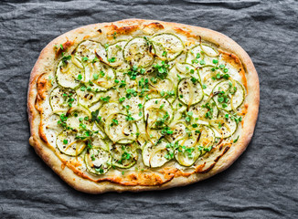 Vegan ricotta and squash pizza on grey background, top view