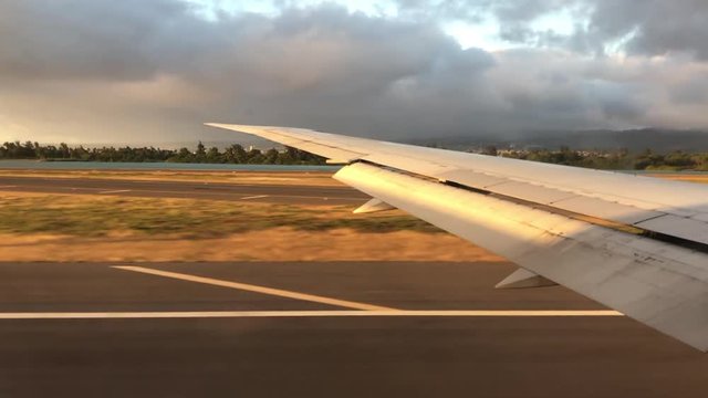 Airplane takeoff from Hawaii just before sunset