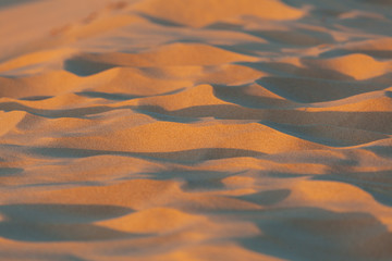 Fototapeta na wymiar Extreme closeup of sand at sunset with shallow focus
