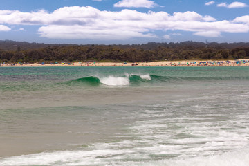 Ocean waves and bathing people at Fingal Bay beach, New South Wales, Australia