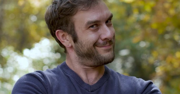 Attractive man pops into frame smiling and looking at the camera