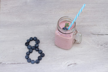 blueberrie shape heart and smoothie in a jar mug with a straw