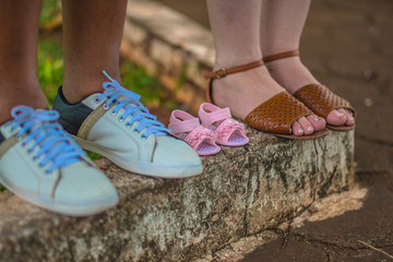 foot close couple delicate little children shoe