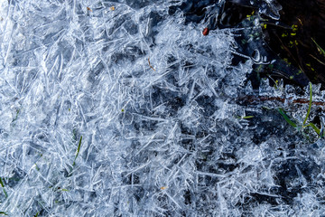 close up of dense ice crystal filled pond surface texture background on cold winter day