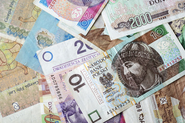 Different countries money background close up. Belarusian rubles, Georgian lari, Polish zloty,...