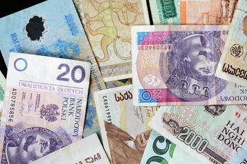Different countries money background close up. Belarusian rubles, Georgian lari, Polish zloty, Israeli shekels, Vietnamese dongs