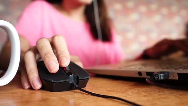 Hand using Computer mouse for online business work	