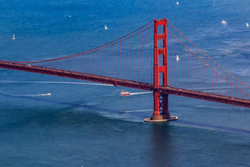 Aerial view of the South tower of Golden Gate Bridge and yachts on the bay, flying over San Francisco, USA