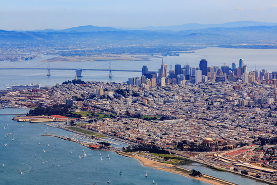 Aerial view of downtown San Francisco and Financial District sky scrapers with Marina district and waterfront in the foreground, circa 2015