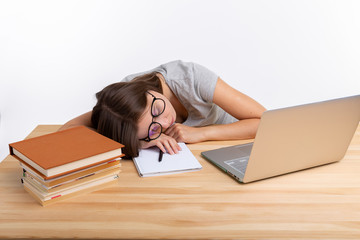 Education, school and university concept - Tired student girl with glasses sleeping with books and laptop