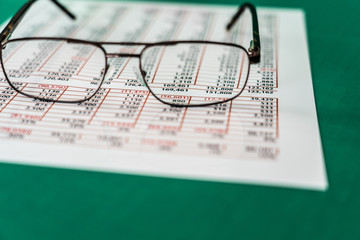 A Pair of reading glasses on spreadsheet report