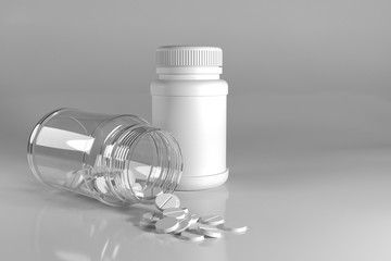 Pills spilling out of pill bottle on white background