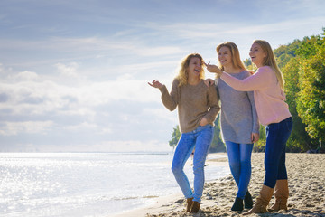 Three fashionable models pointing outdoor