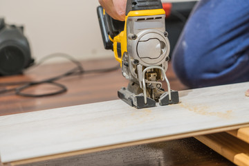 Person cutting floor panels