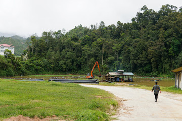 Sand dredging boat ,pump and excavator removing sand from the river bed - Image