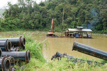 Sand dredging boat ,pump and excavator removing sand from the river bed - Image