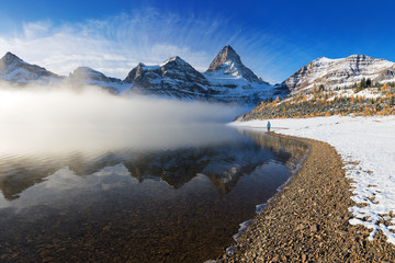 Autumn morning. Mount Assiniboine, also known as Assiniboine Mountain, is a pyramidal peak mountain located on the Great Divide, on the British Columbia/Alberta border in Canada. Banff national park