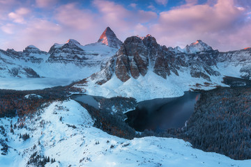 Winter sunrise. Mount Assiniboine, also known as Assiniboine Mountain, is a pyramidal peak mountain...