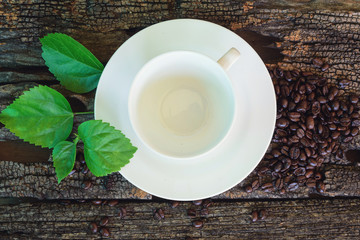 empty cup with coffee bean on wood plate