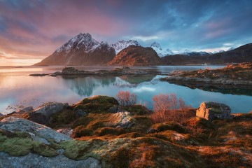 Sunset or sunrise panoramic view on stunning mountains in Lofoten islands, Norway, Mountain coast landscape, Arctic circle. Dramatic weather of a magic sunrise during this last winter. Amazing concept