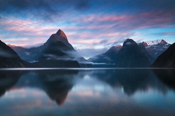 Beautiful sunrise in Milford Sound, New Zealand. - Mitre Peak is the iconic landmark of Milford Sound in Fiordland National Park, South Island of New Zealand Reflection of Mitre peak in the water