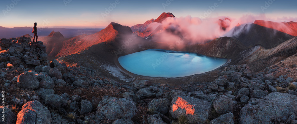 Wall mural mountains and silhouette of standing man. early morning sunrise, landscape scenery of blue lake, wil