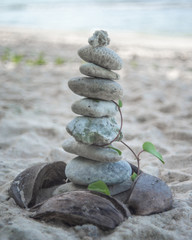 Balanced stone pyramide on the sand beach.
