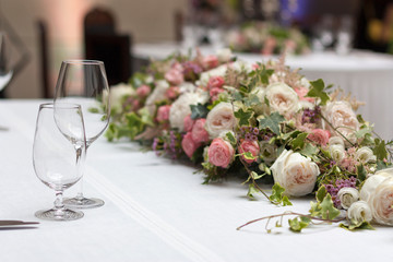 Beautiful floral arrangement on the table in the restaurant on the wedding day