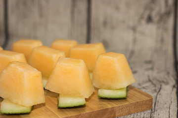 Fresh melons sliced on wooden table
