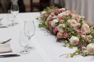 Beautiful floral arrangement on the table in the restaurant on the wedding day