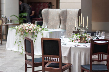 Floral arrangements on the tables in the restaurant. Wedding event