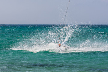 Kite surfer performing difficult tricks in high winds. Extrme sports shot in Tarifa, Andalusia,...