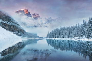 First snow Morning at Moraine Lake in Banff National Park Alberta Canada Snow-covered winter mountain lake in a winter atmosphere. Beautiful background photo - obrazy, fototapety, plakaty