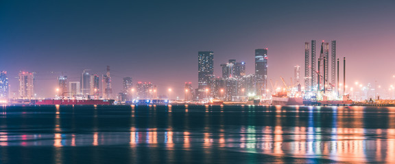 Fototapeta na wymiar The Dubai skyline at night from Port Rashid, Dubai, UAE