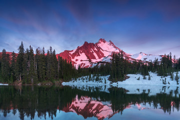 At 10,492 feet high, Mt Jefferson is Oregon's second tallest mountain. Reflected here in Scout Lake at sunset. The snow covered central Oregon Cascade volcano Mount Jefferson. Wilderness Area, Oregon