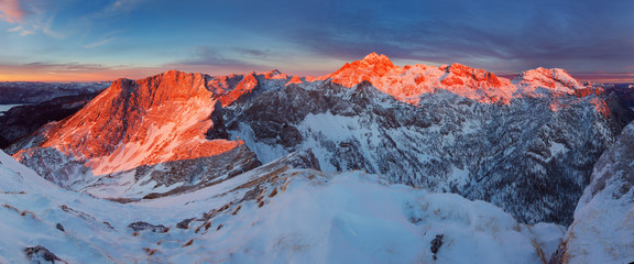 First snow and magnificent sunset in the mountains. Photo of amazing scene in European Alps. View to highest peak of Slovenia. Triglav National Park, Julian Alps Beautiful winter landscape with snow