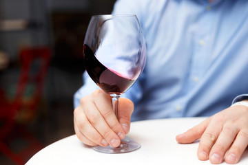 male sommelier is checking and testing red wine