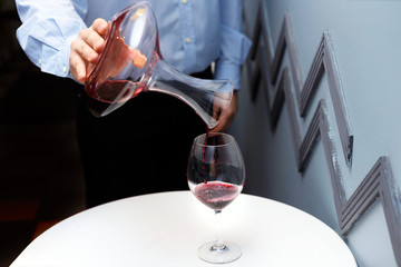 male sommelier is checking and testing red wine