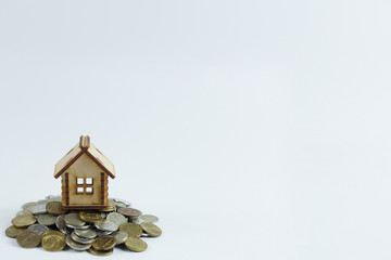 Finance, money saving, wooden house on white background