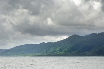 Tropical sea, monsoon storm heavy clouds and tropical Koh Chang island on horizon in Thailand