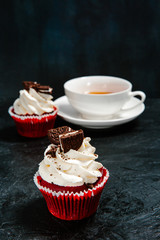 Cupcakes with cream and cookies and a Cup of tea